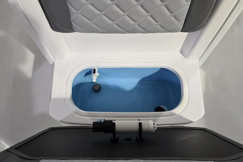 Slide: The Image of Livewell compartment in 2026 NauticStar 242L Offshore boat, featuring quilted seating. - 19