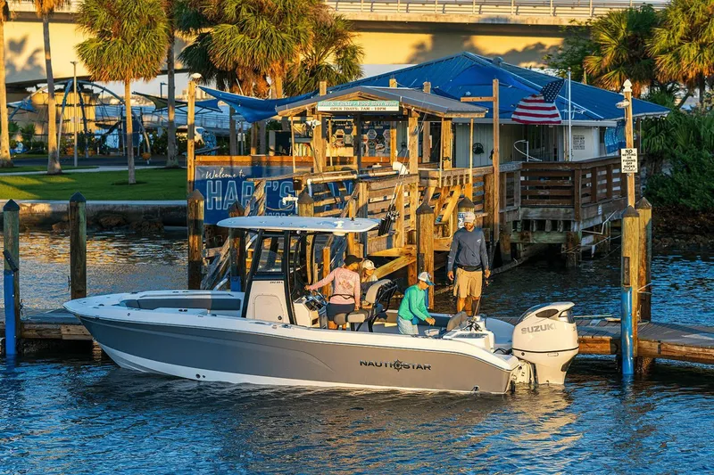 Slide: The Image of Close-up of a NauticStar 242L Offshore 2026 boat propeller, showcasing its polished metal blades. - 2