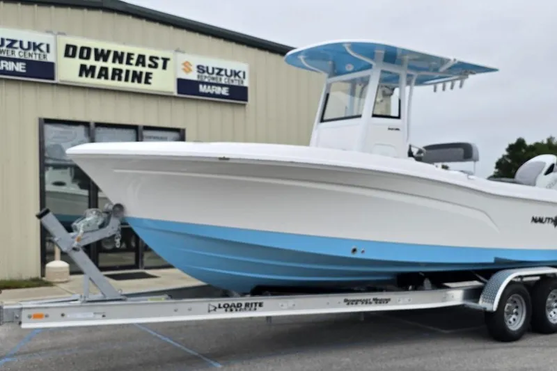 Slide: The Image of 2026 NauticStar 242L Offshore boat on trailer at Downeast Marine dealership. - 27