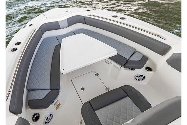 Slide: The Image of 2026 NauticStar 242L Offshore boat with gray quilted seating and Suzuki engine. - 4