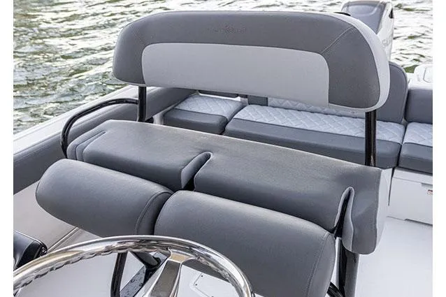 Slide: The Image of 2026 NauticStar 242L Offshore boat interior with gray quilted seating and cup holders. - 7