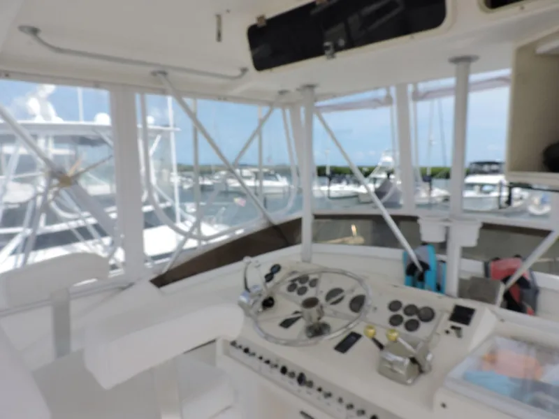 Slide: The Image of Interior view of 1990 Post 44 Sport Fisherman boat cockpit with steering controls. - 15