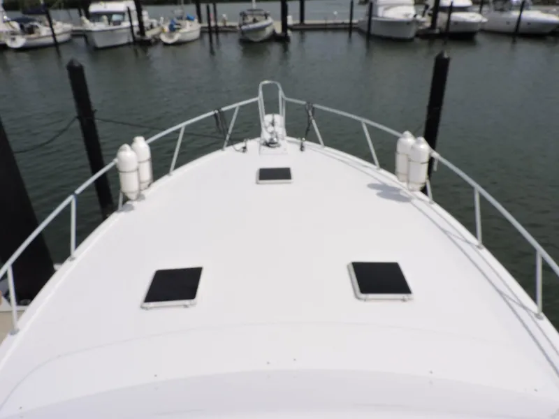 Slide: The Image of 1990 Post 44 Sport Fisherman boat docked at marina, view from bow. - 18