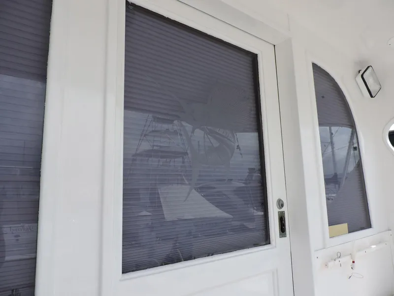 Slide: The Image of 1990 Post 44 Sport Fisherman boat with closed cabin door and window blinds. - 20
