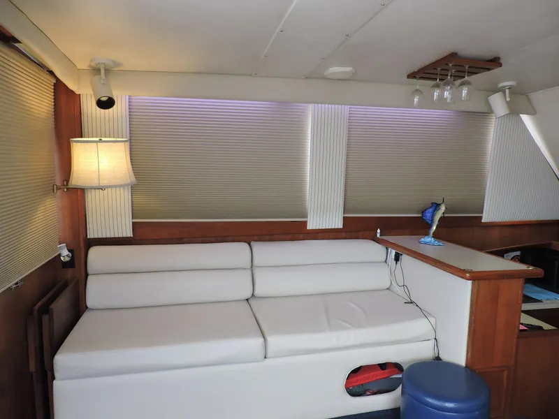 Slide: The Image of Interior of 1990 Post 44 Sport Fisherman with white sofa and wooden accents. - 24