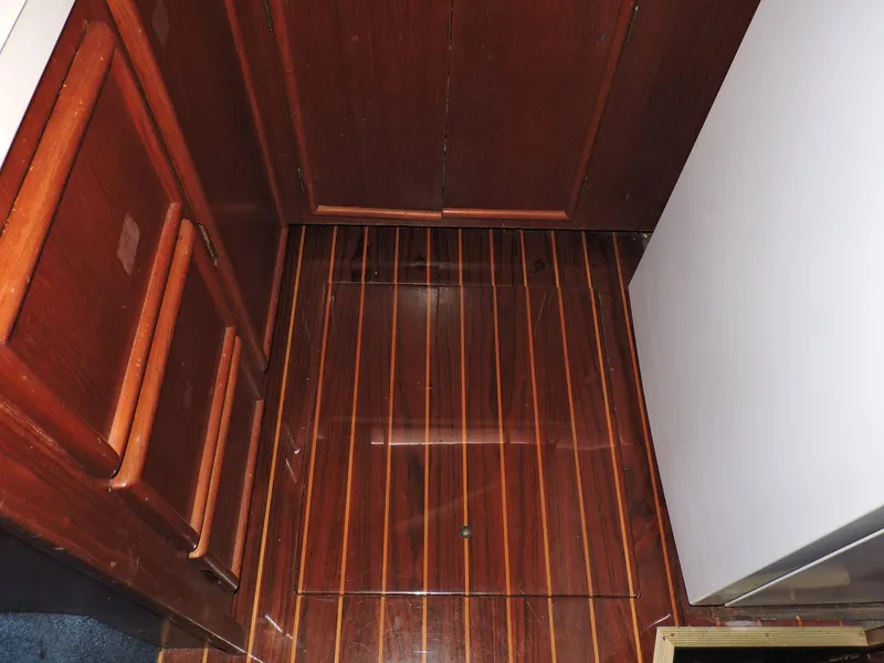 Slide: The Image of Interior of 1990 Post 44 Sport Fisherman with polished wood flooring and cabinetry. - 30