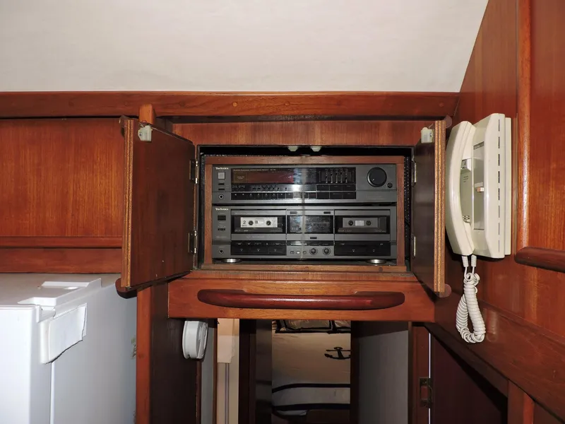 Slide: The Image of 1990 Post 44 Sport Fisherman interior with vintage stereo system and wall-mounted phone. - 32