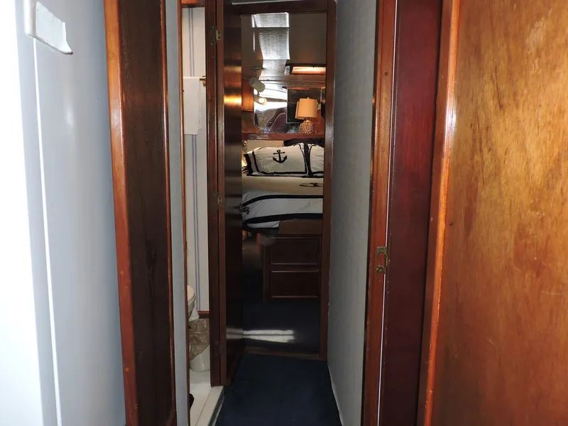 Slide: The Image of Narrow hallway inside 1990 Post 44 Sport Fisherman boat, leading to a cozy cabin. - 35