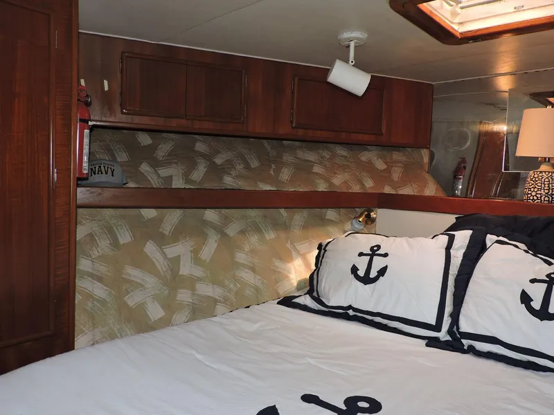 Slide: The Image of Cozy cabin interior of 1990 Post 44 Sport Fisherman with nautical-themed bedding. - 39