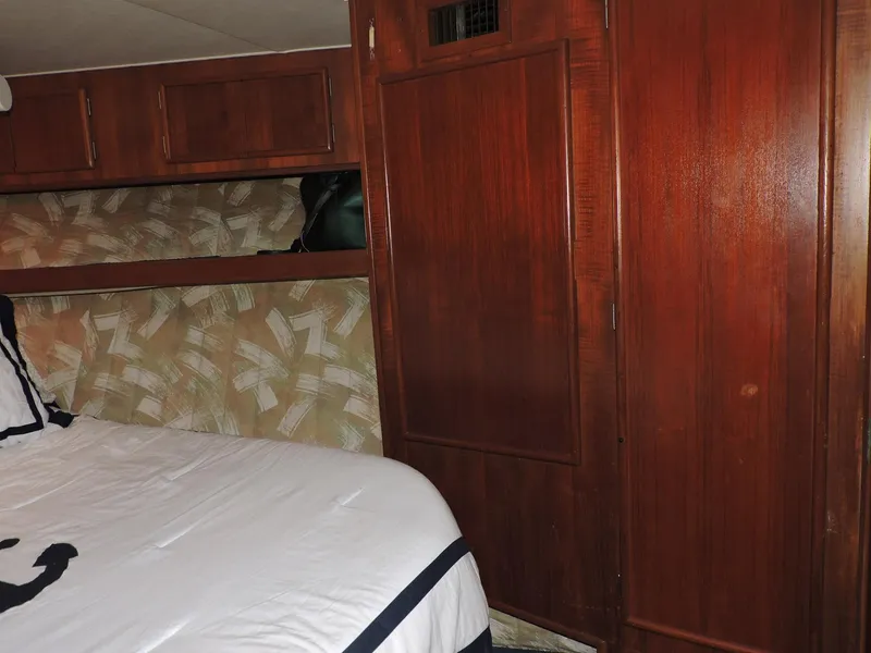 Slide: The Image of Interior cabin of 1990 Post 44 Sport Fisherman with wood paneling and bed. - 40