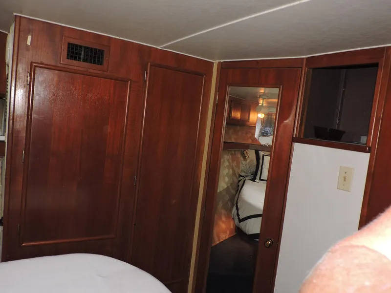 Slide: The Image of Interior of 1990 Post 44 Sport Fisherman yacht with wooden cabinetry and cozy sleeping area. - 42