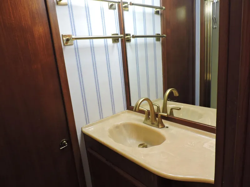 Slide: The Image of Bathroom vanity with gold faucet in 1990 Post 44 Sport Fisherman yacht. - 46