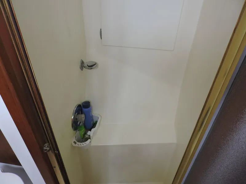 Slide: The Image of Shower area inside 1990 Post 44 Sport Fisherman boat, featuring a compact design. - 47