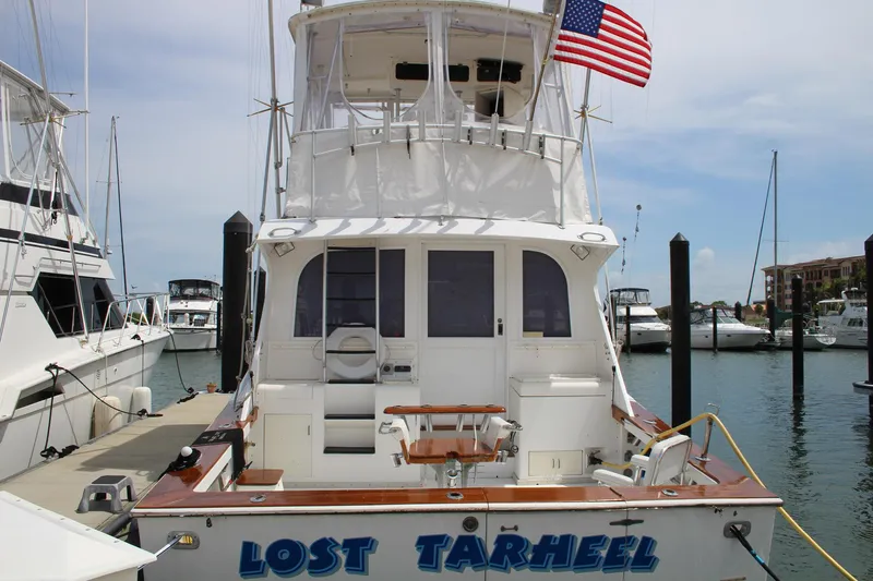 Slide: The Image of 1990 Post 44 Sport Fisherman boat named "Lost Tarheel" docked at a marina. - 5