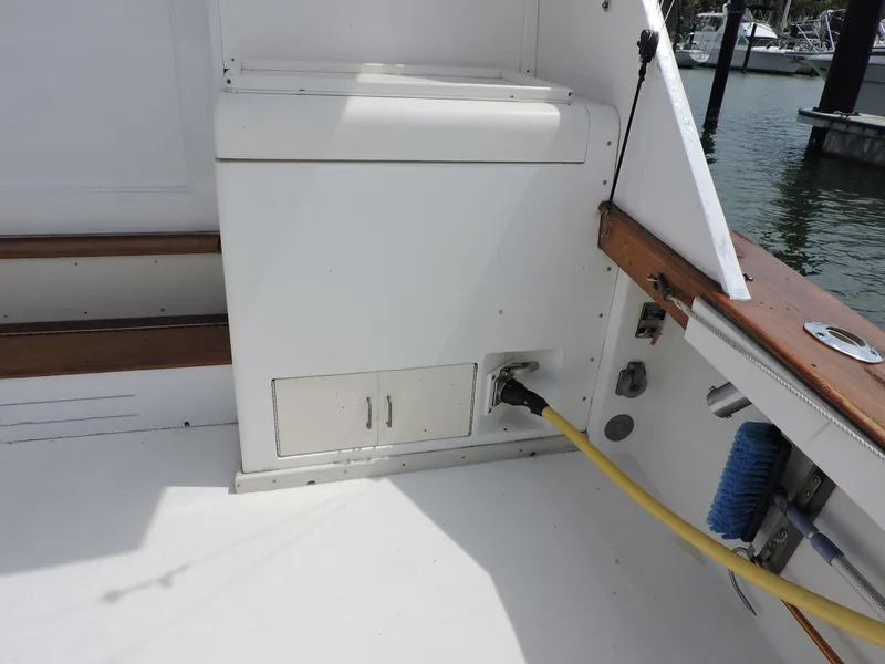 Slide: The Image of 1990 Post 44 Sport Fisherman boat deck with storage and utility connections. - 9