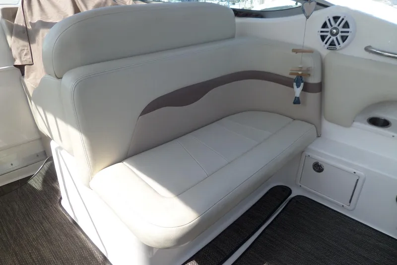 Slide: The Image of 2005 Chaparral Signature 270 boat interior with cushioned seating and speaker. - 10