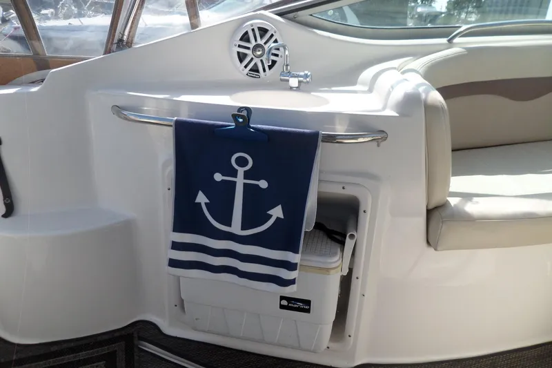 Slide: The Image of 2005 Chaparral Signature 270 interior with anchor-themed towel and seating area. - 12