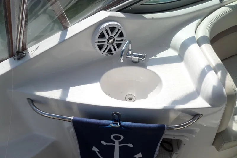 Slide: The Image of 2005 Chaparral Signature 270 boat interior with sink, speaker, and anchor-themed towel. - 13