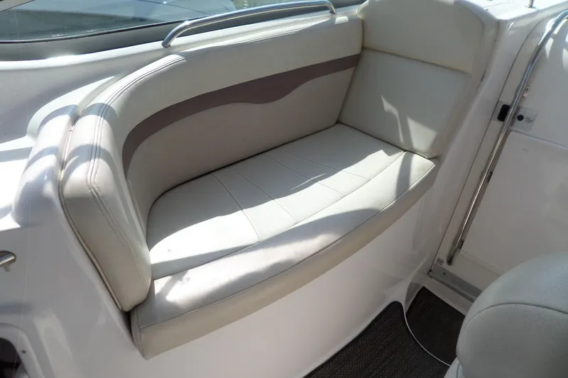 Slide: The Image of 2005 Chaparral Signature 270 boat interior with beige seating and stainless steel railing. - 14