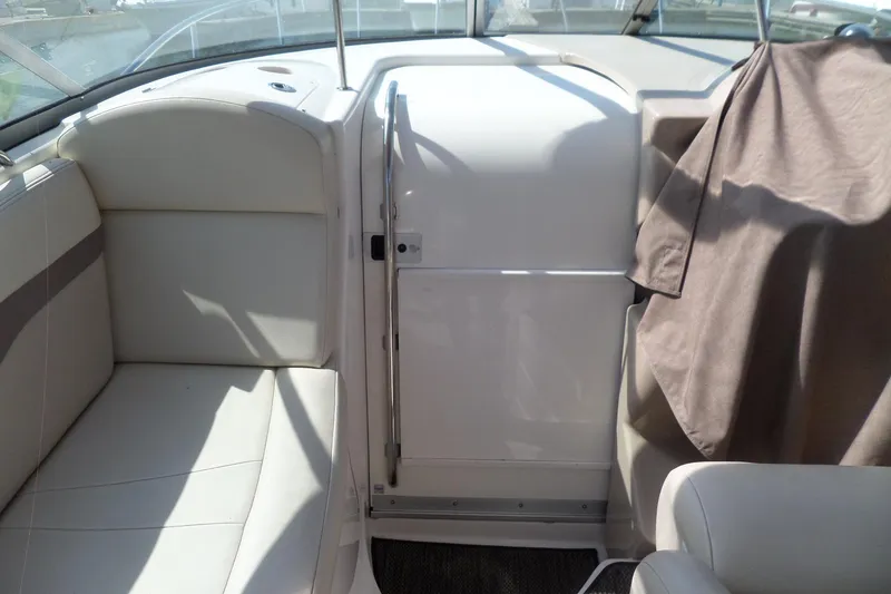 Slide: The Image of 2005 Chaparral Signature 270 boat interior with white seating and covered area. - 15