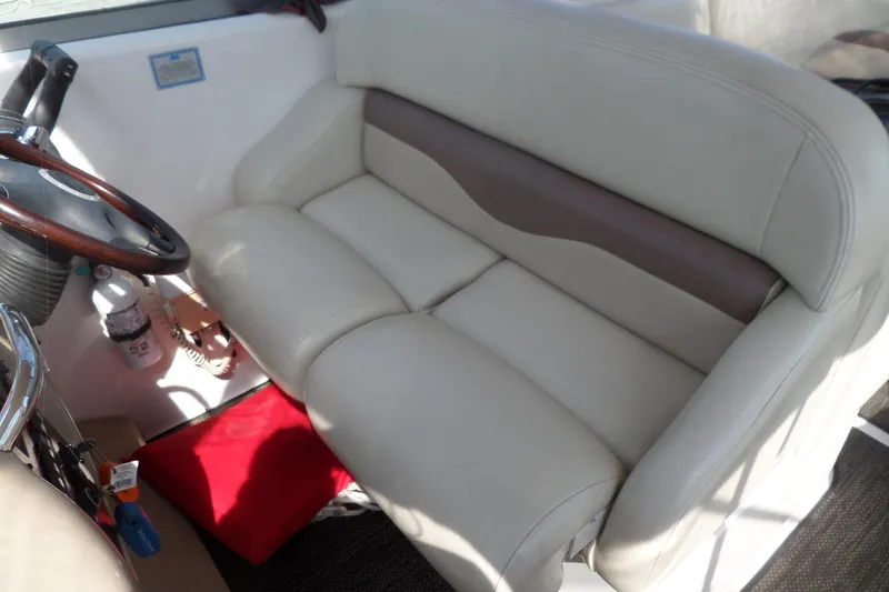 Slide: The Image of 2005 Chaparral Signature 270 boat interior with beige seating and steering wheel. - 16