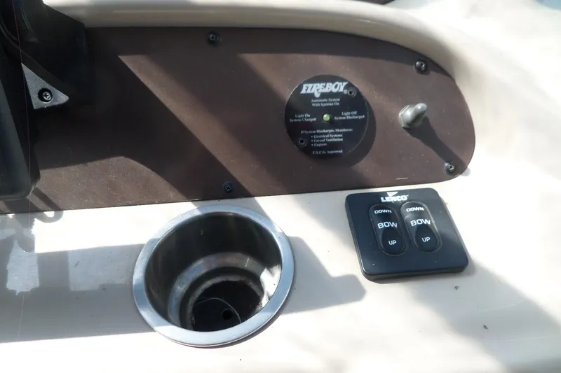 Slide: The Image of Control panel of a 2005 Chaparral Signature 270 boat with cup holder and switches. - 20