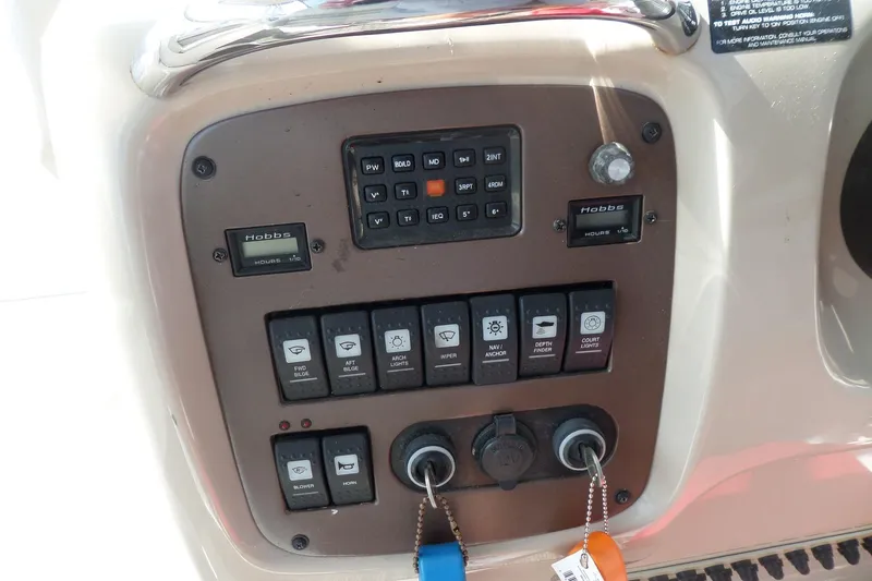 Slide: The Image of Control panel of a 2005 Chaparral Signature 270 boat with switches and gauges. - 22