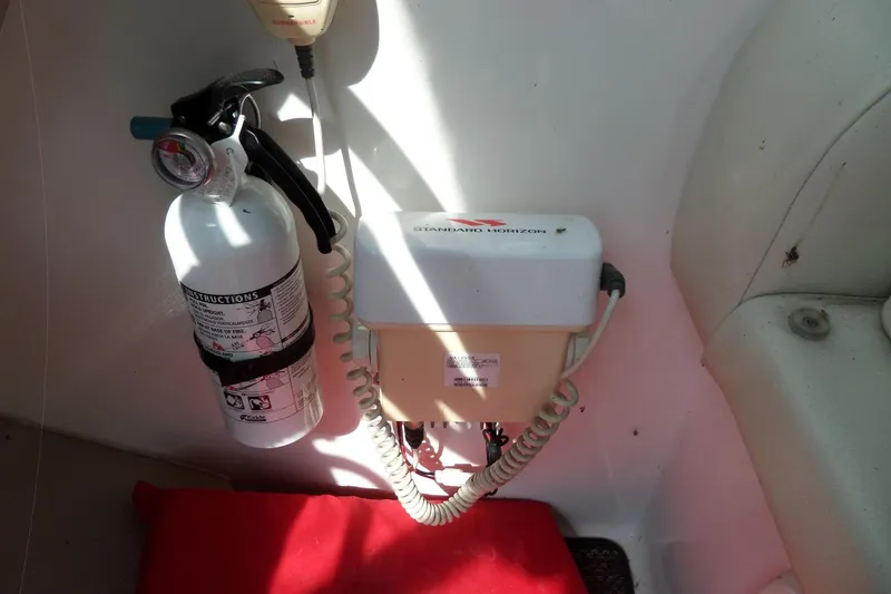 Slide: The Image of Fire extinguisher and radio equipment on 2005 Chaparral Signature 270 boat interior. - 25