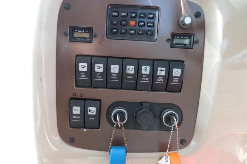 Slide: The Image of Control panel of a 2005 Chaparral Signature 270 boat with various switches and indicators. - 28
