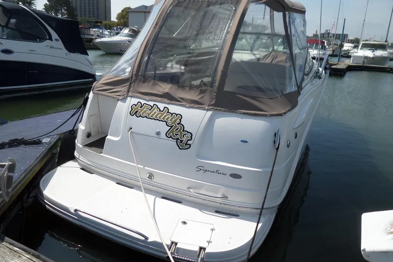 Slide: The Image of 2005 Chaparral Signature 270 boat docked at marina, featuring "Holiday Rex" decal. - 3