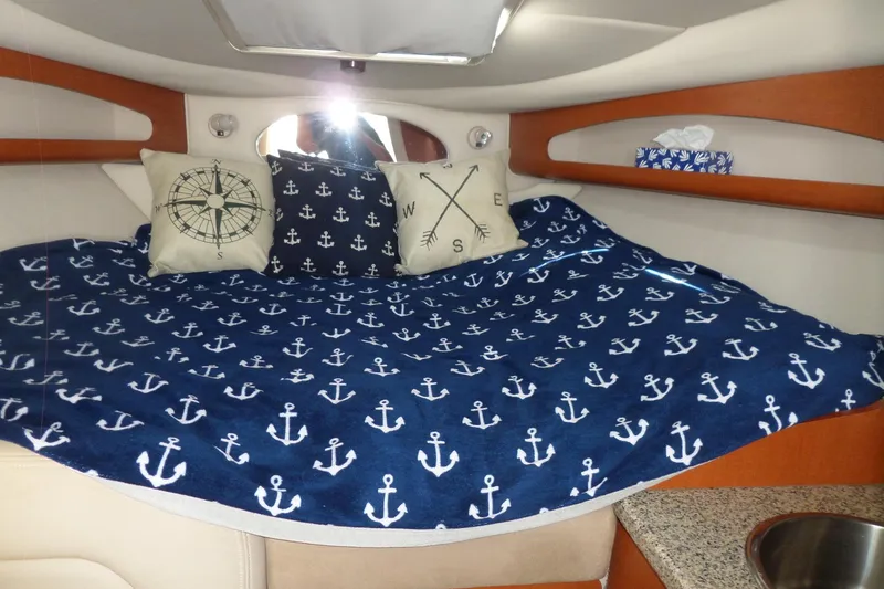 Slide: The Image of Cozy cabin interior of 2005 Chaparral Signature 270 with nautical-themed bedding and pillows. - 40