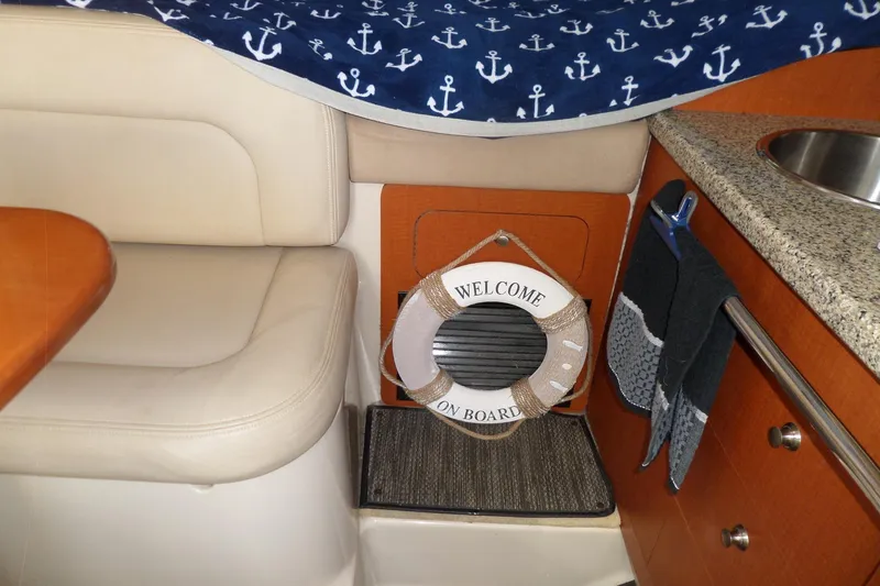 Slide: The Image of Interior of 2005 Chaparral Signature 270 with nautical decor and welcome sign. - 41