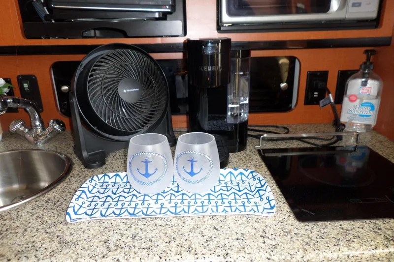 Slide: The Image of 2005 Chaparral Signature 270 kitchen with fan, Keurig, nautical glasses, and hand sanitizer. - 44