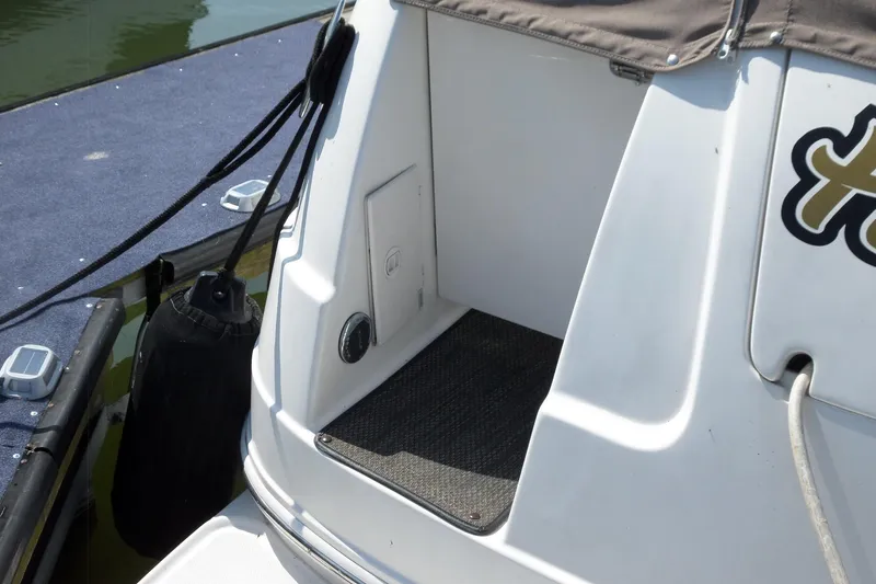 Slide: The Image of 2005 Chaparral Signature 270 boat stern detail with dock and fender. - 5