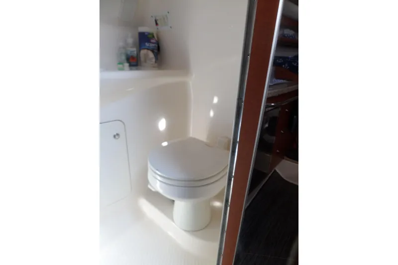 Slide: The Image of 2005 Chaparral Signature 270 boat bathroom with toilet and toiletries. - 50
