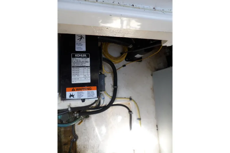 Slide: The Image of Engine compartment of 2005 Chaparral Signature 270 with Kohler generator and warning label. - 54