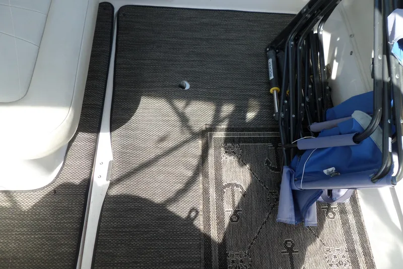 Slide: The Image of Interior of 2005 Chaparral Signature 270 boat with seating and folded chairs. - 62