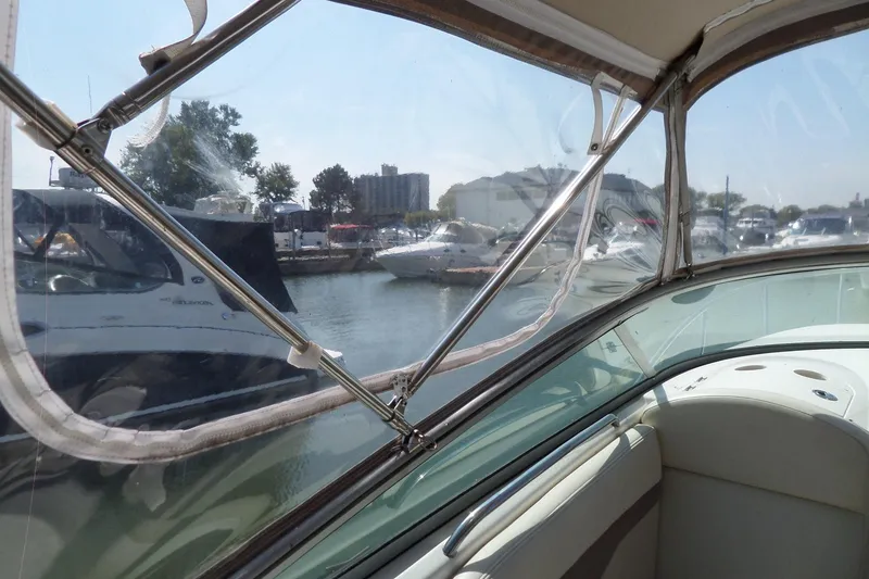 Slide: The Image of 2005 Chaparral Signature 270 boat interior view, docked in a marina with other boats. - 63