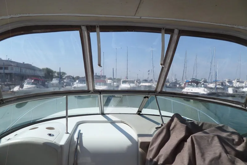 Slide: The Image of 2005 Chaparral Signature 270 boat interior view at marina, showcasing docked vessels. - 65