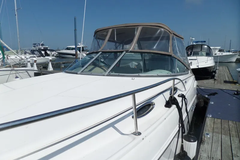 Slide: The Image of 2005 Chaparral Signature 270 boat docked at marina under clear blue sky. - 67