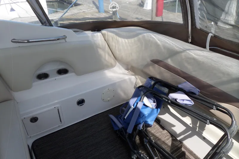 Slide: The Image of Interior of 2005 Chaparral Signature 270 boat with seating and folded chairs. - 8