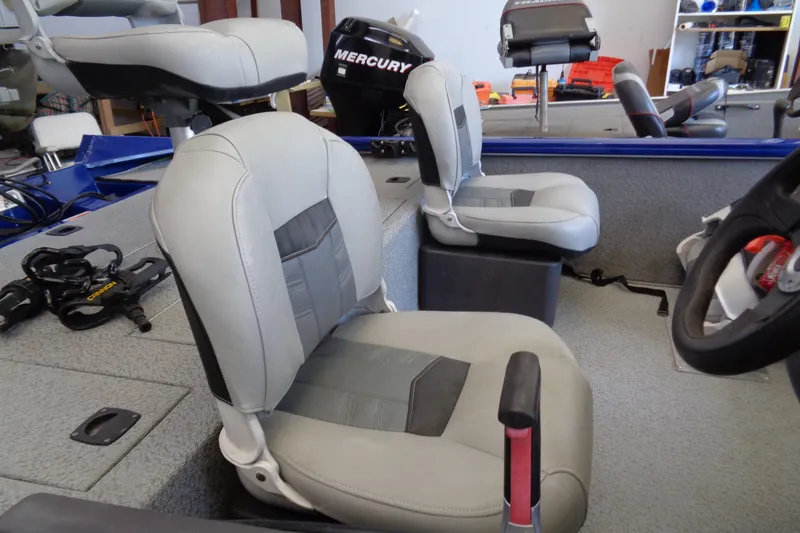 Slide: The Image of 2018 Bass Tracker PT175 boat interior with gray seating and Mercury engine. - 10