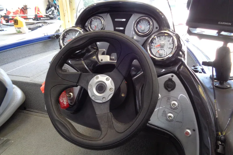 Slide: The Image of 2018 Bass Tracker PT175 dashboard with steering wheel and gauges. - 12
