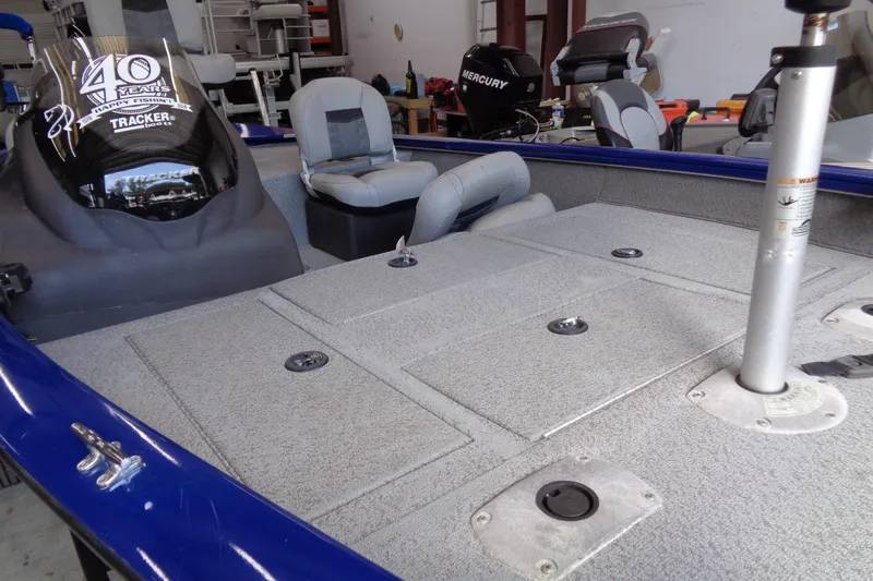 Slide: The Image of 2018 Bass Tracker PT175 boat interior with seating and storage compartments. - 14