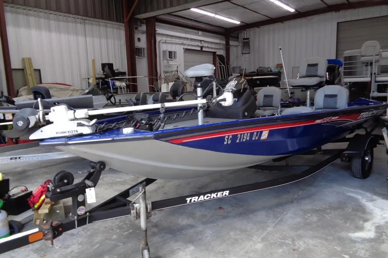 Slide: The Image of 2018 Bass Tracker PT175 boat in a garage, equipped with Minn Kota motor. - 16