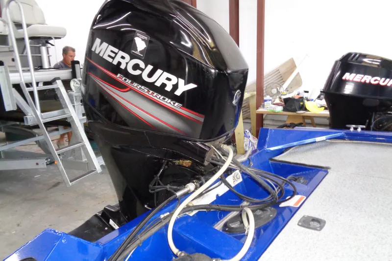 Slide: The Image of 2018 Bass Tracker PT175 with Mercury FourStroke engine in a workshop setting. - 18