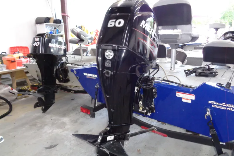 Slide: The Image of 2018 Bass Tracker PT175 boat with Mercury 60 and 40 horsepower engines in a garage. - 19