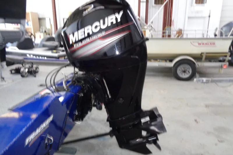 Slide: The Image of 2018 Bass Tracker PT175 with Mercury outboard motor in a garage setting. - 20
