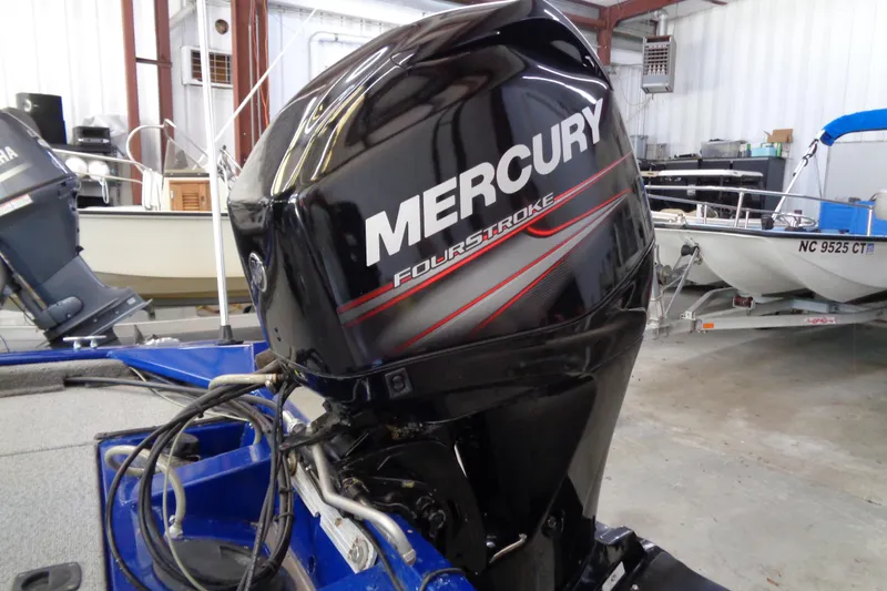 Slide: The Image of 2018 Bass Tracker PT175 with Mercury FourStroke engine in a garage setting. - 21