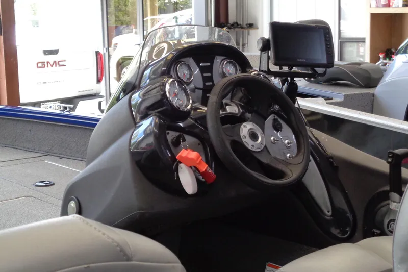 Slide: The Image of 2018 Bass Tracker PT175 boat dashboard with steering wheel and gauges. - 22